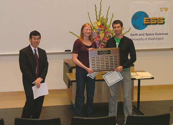 Photo of Joseph MacGregor and Emily Mullen receiving the top graduate student Johnston Prize.